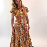 Woman wearing a floral dress against a white background