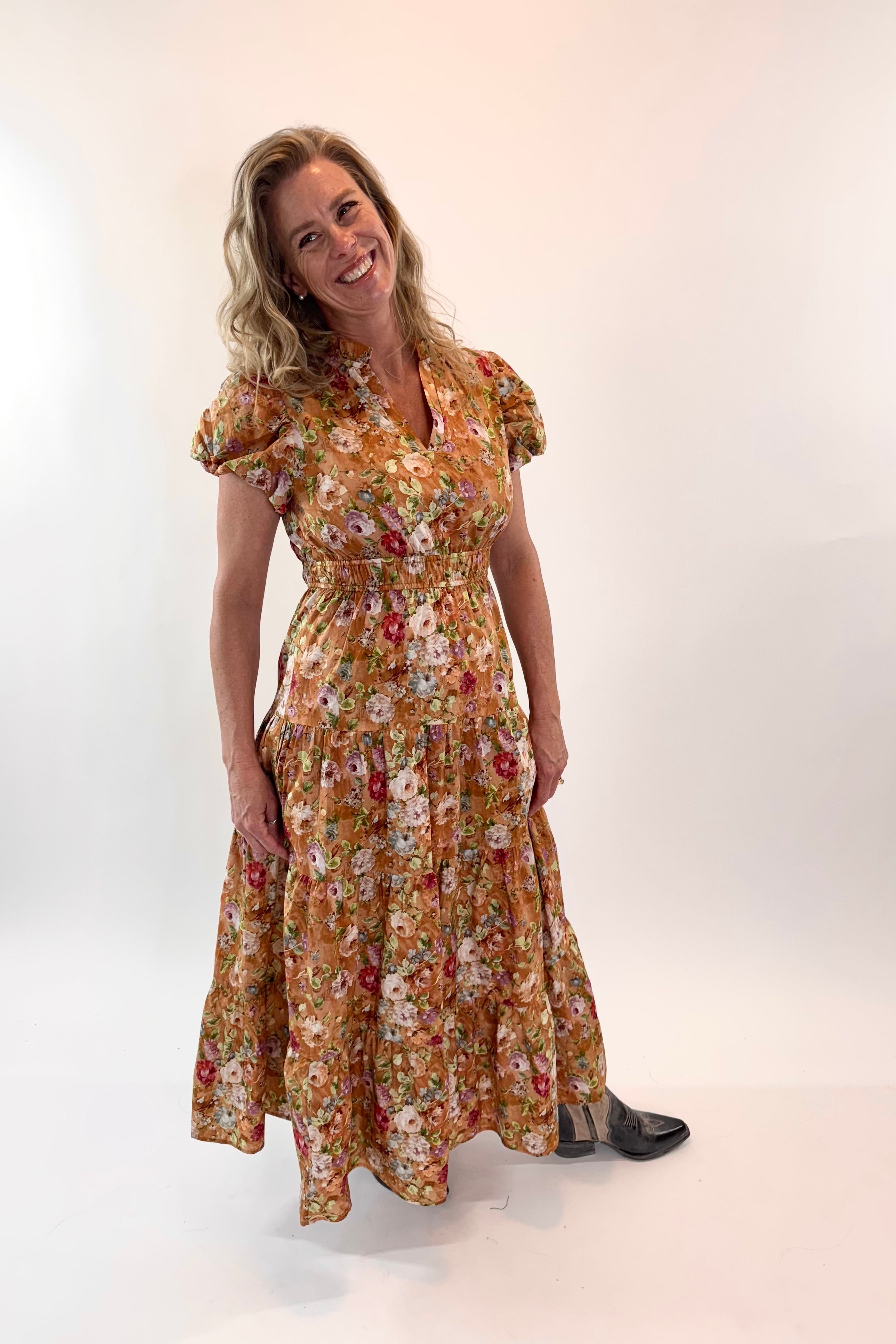 Woman wearing a floral dress against a white background