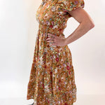 Woman wearing a floral dress against a white background