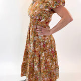 Woman wearing a floral dress against a white background