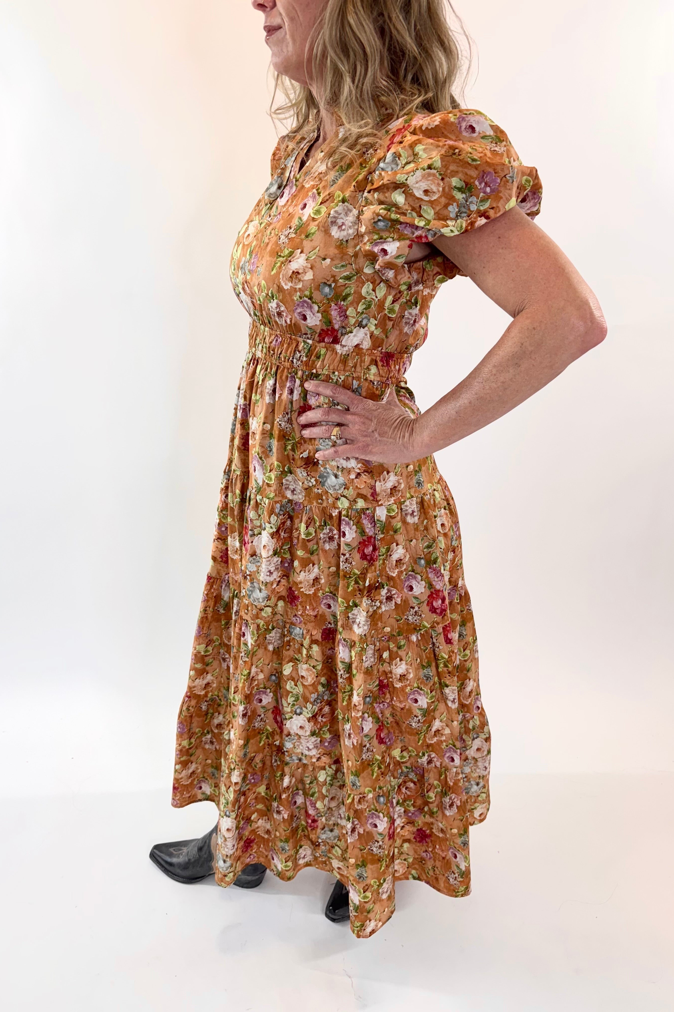 Woman wearing a floral dress against a white background