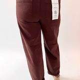 Brown pants with a visible brand label on a white background