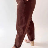 Brown pants worn by a person on a white background