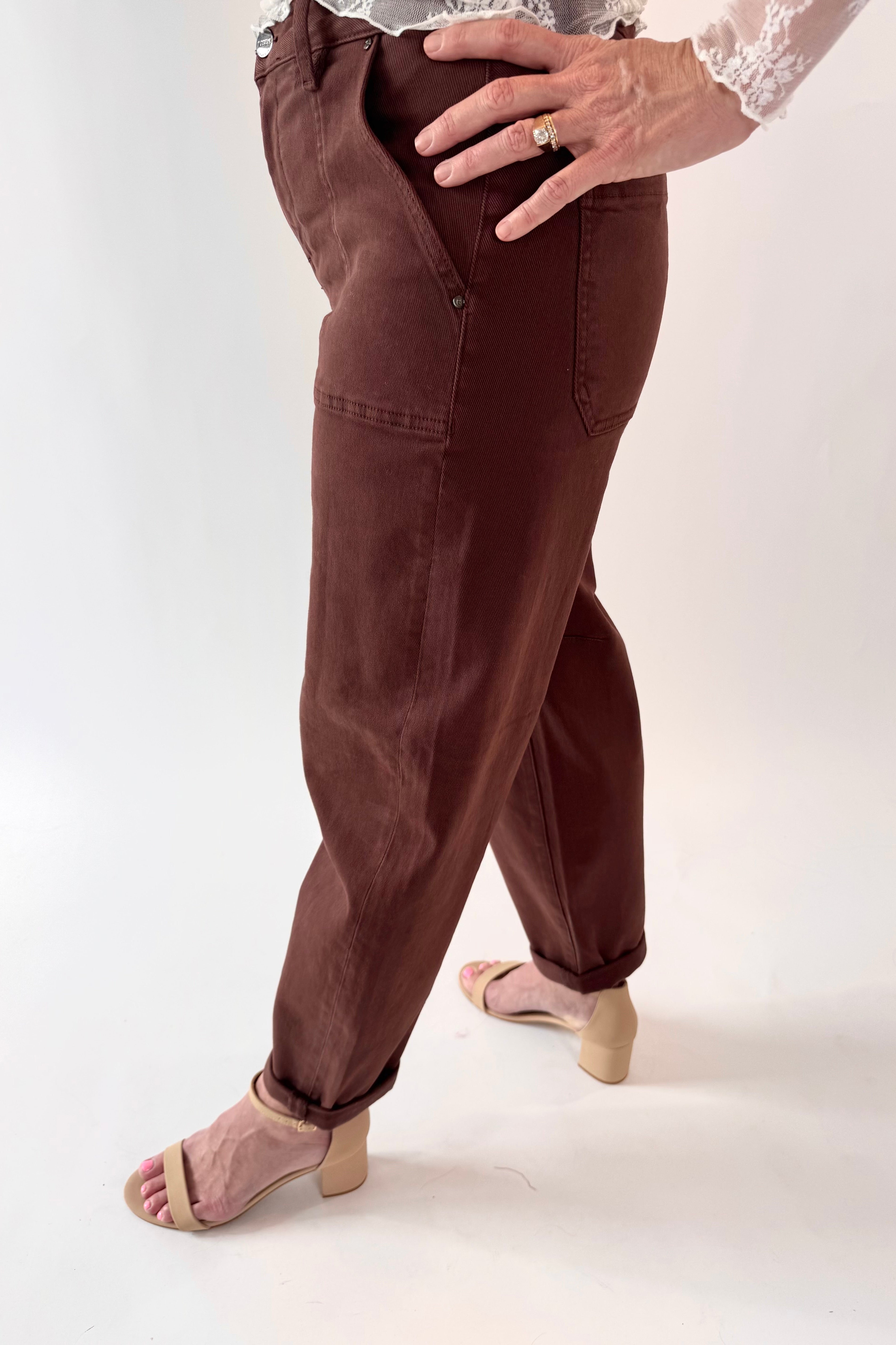 Brown pants worn by a person on a white background