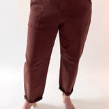 Brown pants worn by a person on a white background
