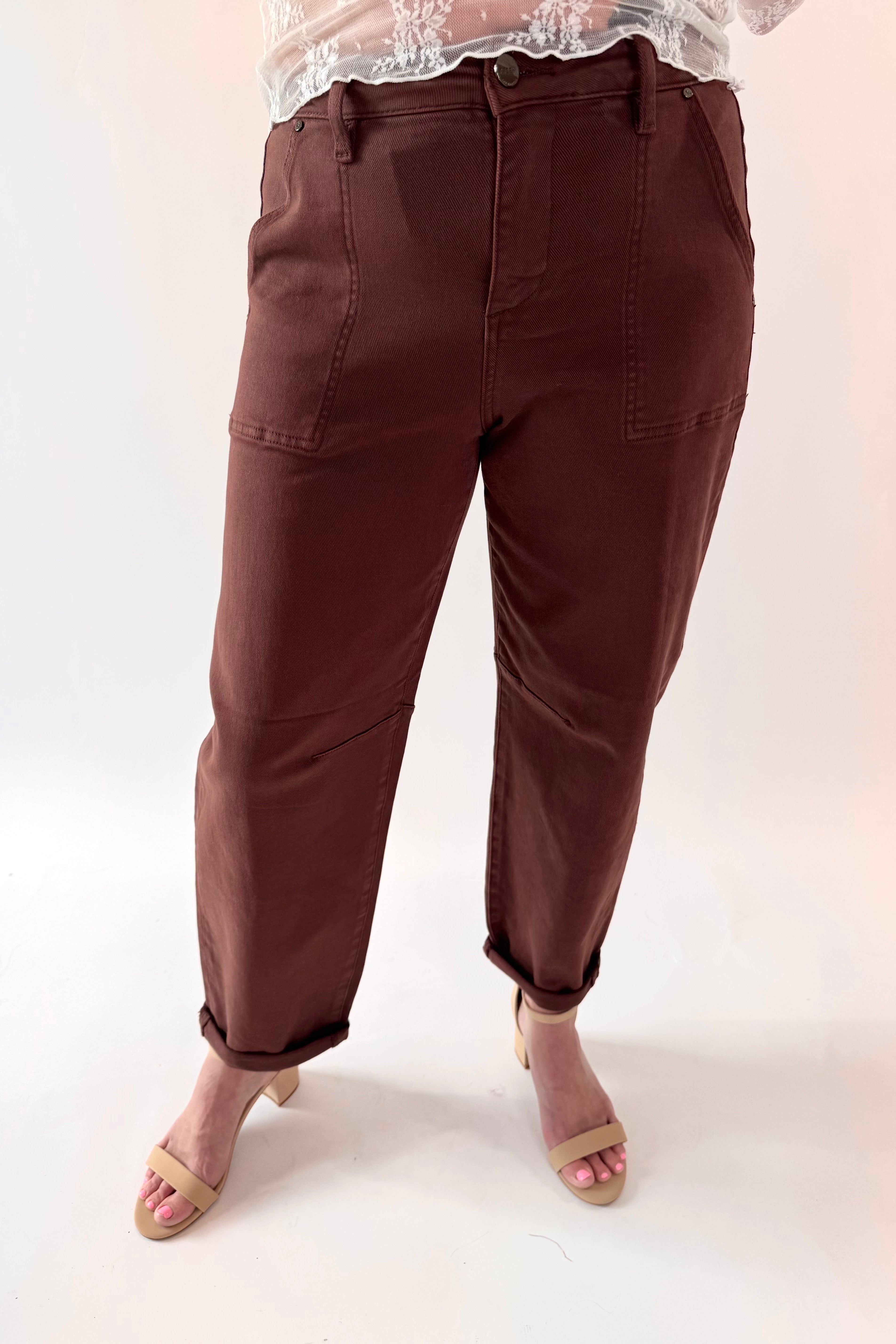 Brown pants worn by a person on a white background