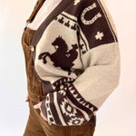 Person wearing a patterned sweater with horse design on a plain background