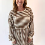 Woman wearing a striped dress against a white background