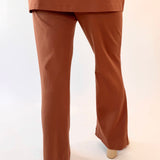 Brown outfit with a top and wide-leg pants on a white background