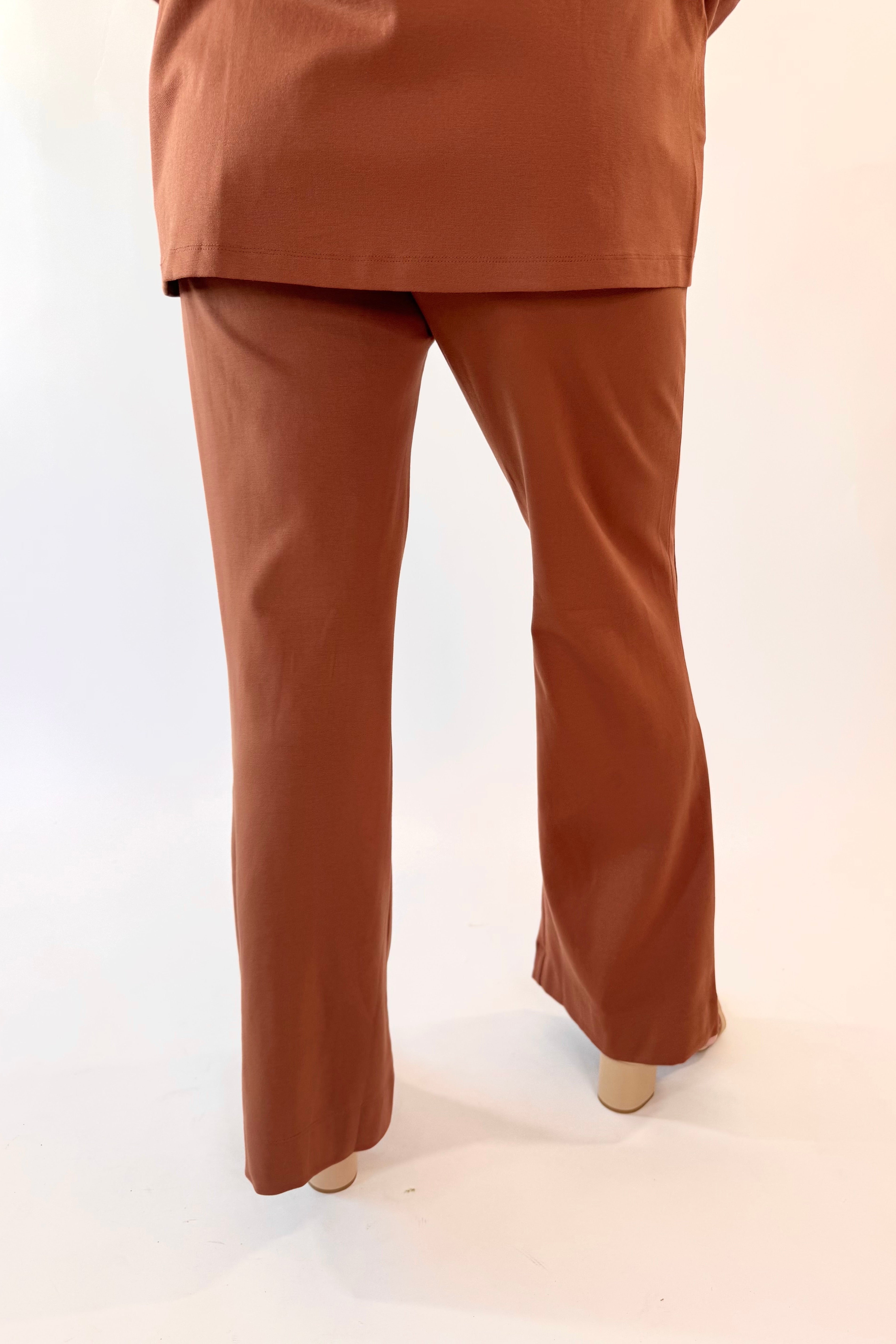 Brown outfit with a top and wide-leg pants on a white background