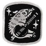 Embroidered patch with a wolf playing a guitar on a black background