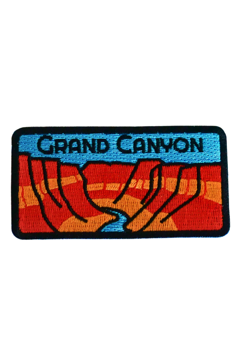 Embroidered patch of the Grand Canyon with red and blue design on a black background