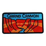 Embroidered patch of the Grand Canyon with red and blue design on a black background