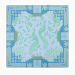 Decorative placemat with green floral design on a blue geometric border. Isla Mat in Tube | Oh My Mahjong
