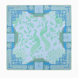 Decorative placemat with green floral design on a blue geometric border. Isla Mat in Tube | Oh My Mahjong