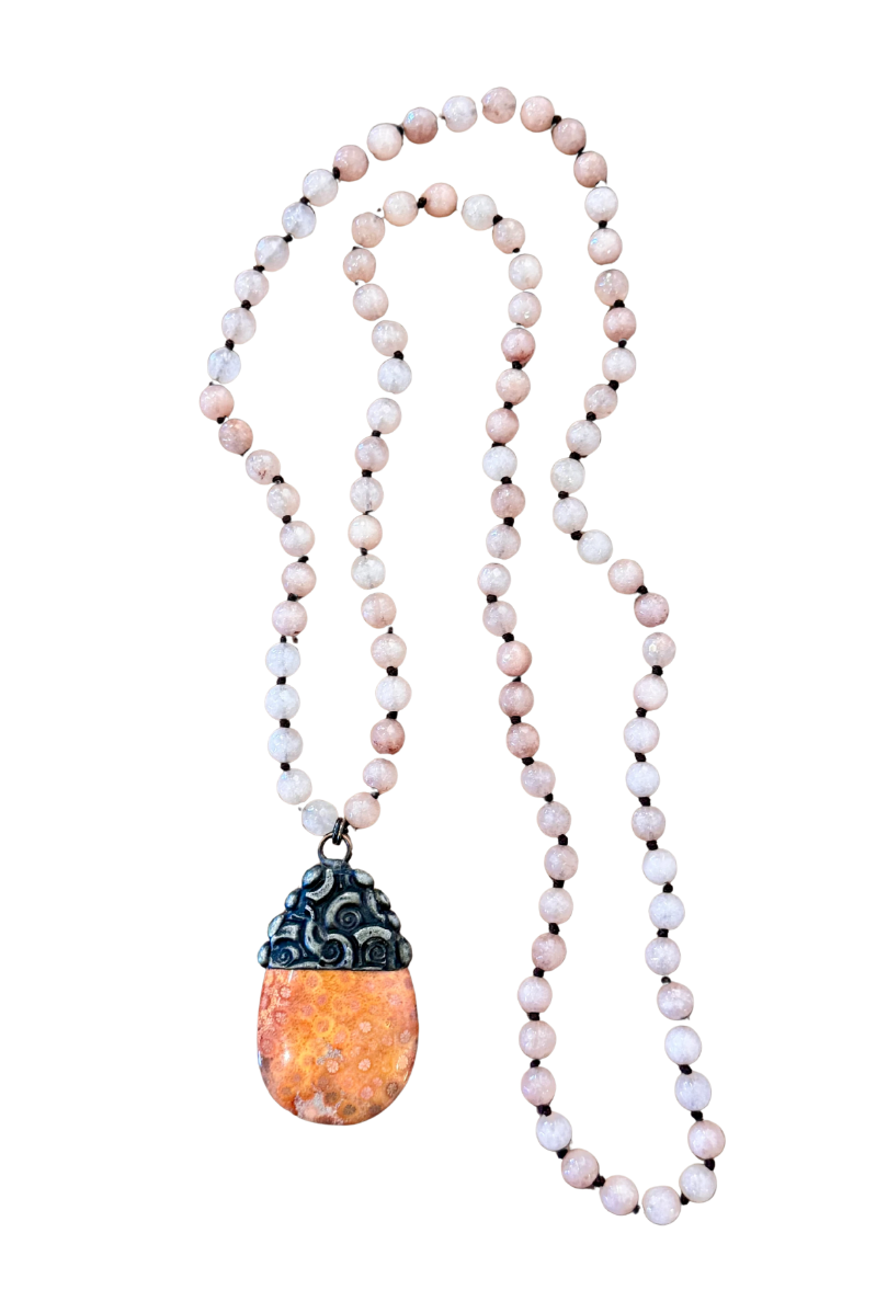 Necklace with beads and a pendant on a white background
