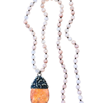 Necklace with beads and a pendant on a white background
