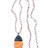 Necklace with beads and a pendant on a white background