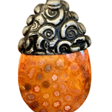 Pendant with orange base and silver top on a white background