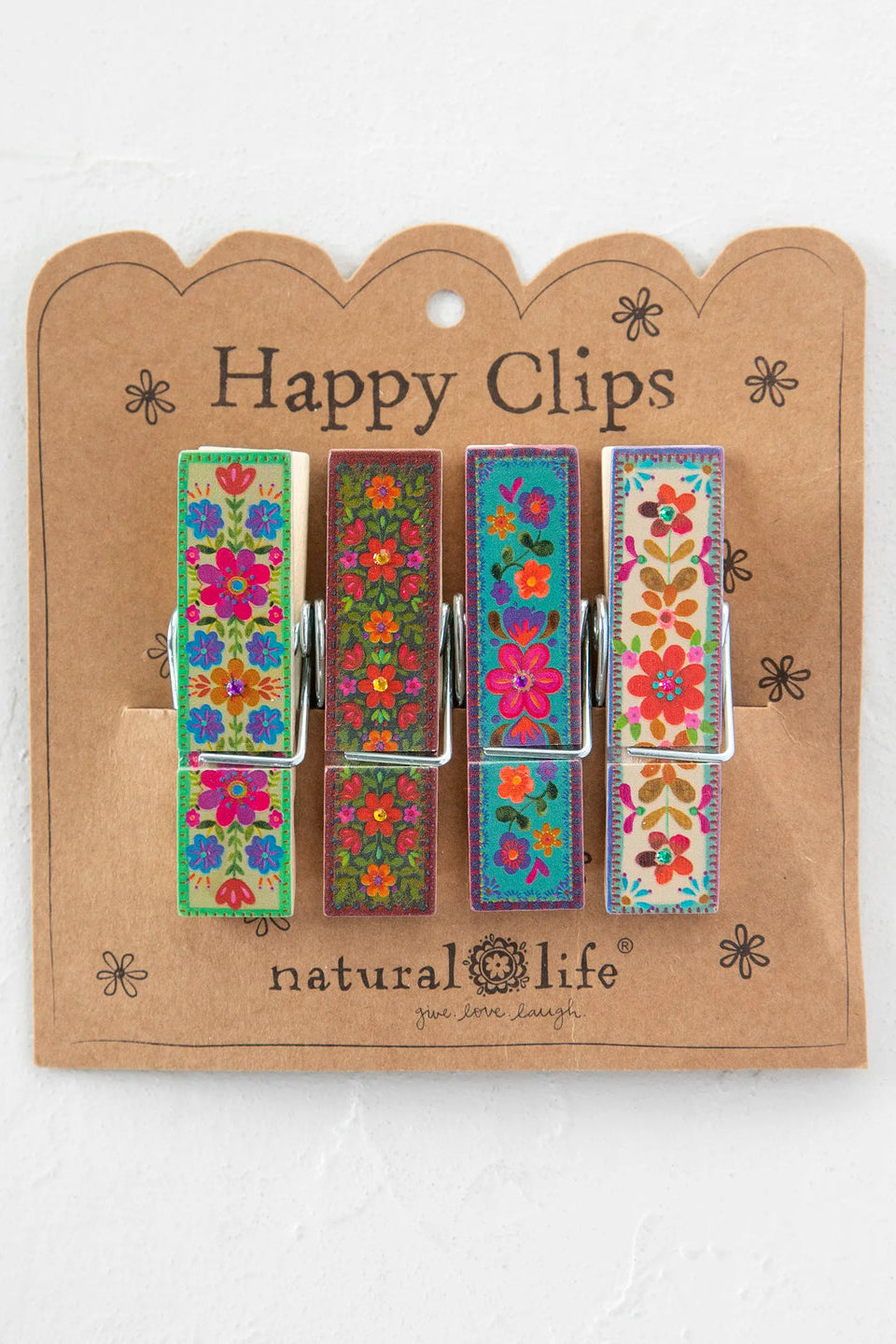 Happy Clips packaging with colorful floral designs on a white background