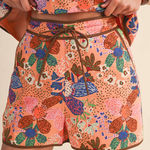 Colorful floral-patterned shorts with a brown drawstring on a neutral background wearing Wildflower Market Shorts