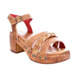 A tan-colored leather sandal with braided leather accents, metal studs, red leather lining, and a manageable heel height, displayed against a white background.