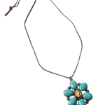 Necklace with a turquoise flower pendant on a white background