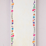 Notepad with floral border and motivational quote on a light background