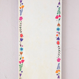 Notepad with floral border and motivational quote on a light background