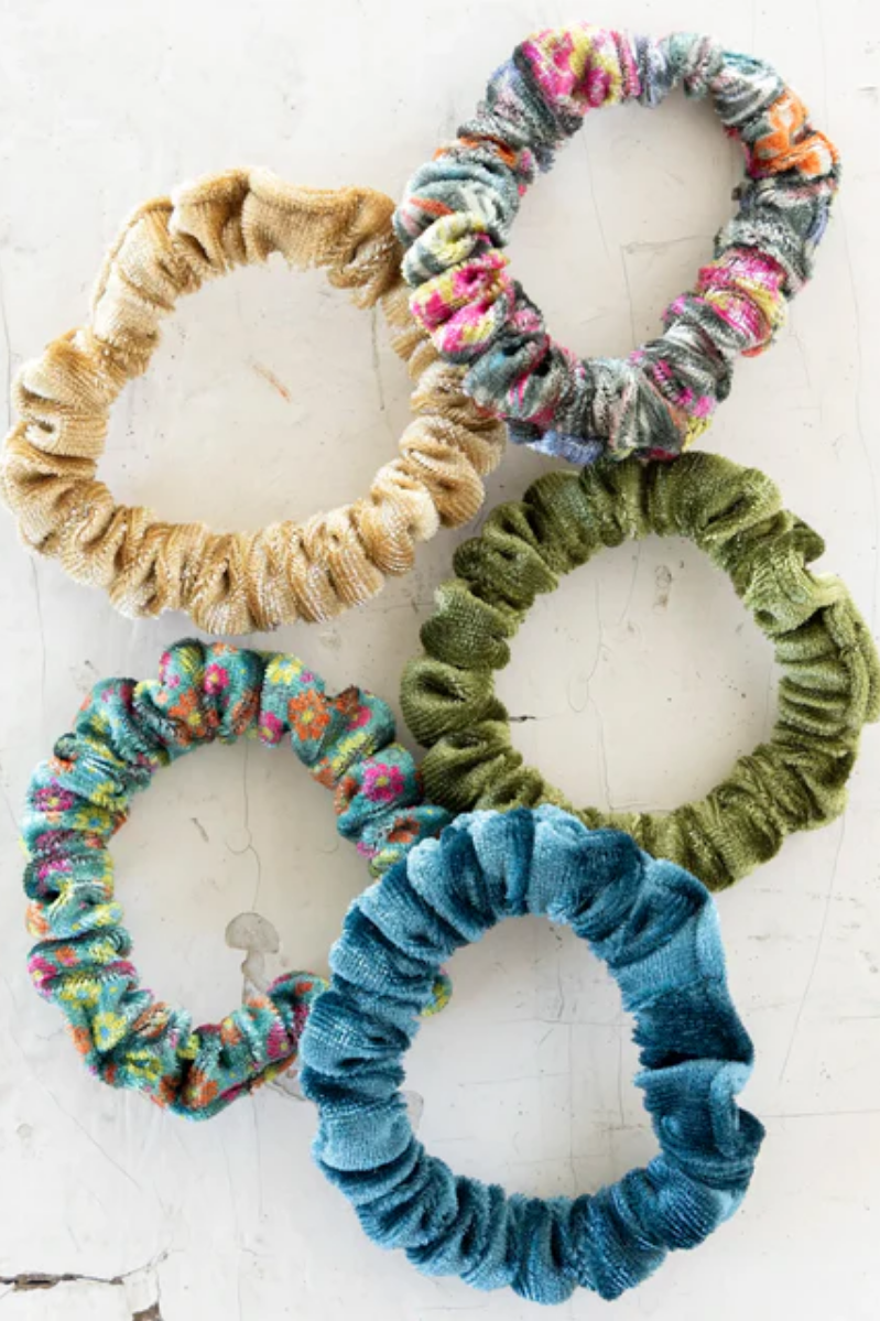 Five colorful scrunchies on a white background