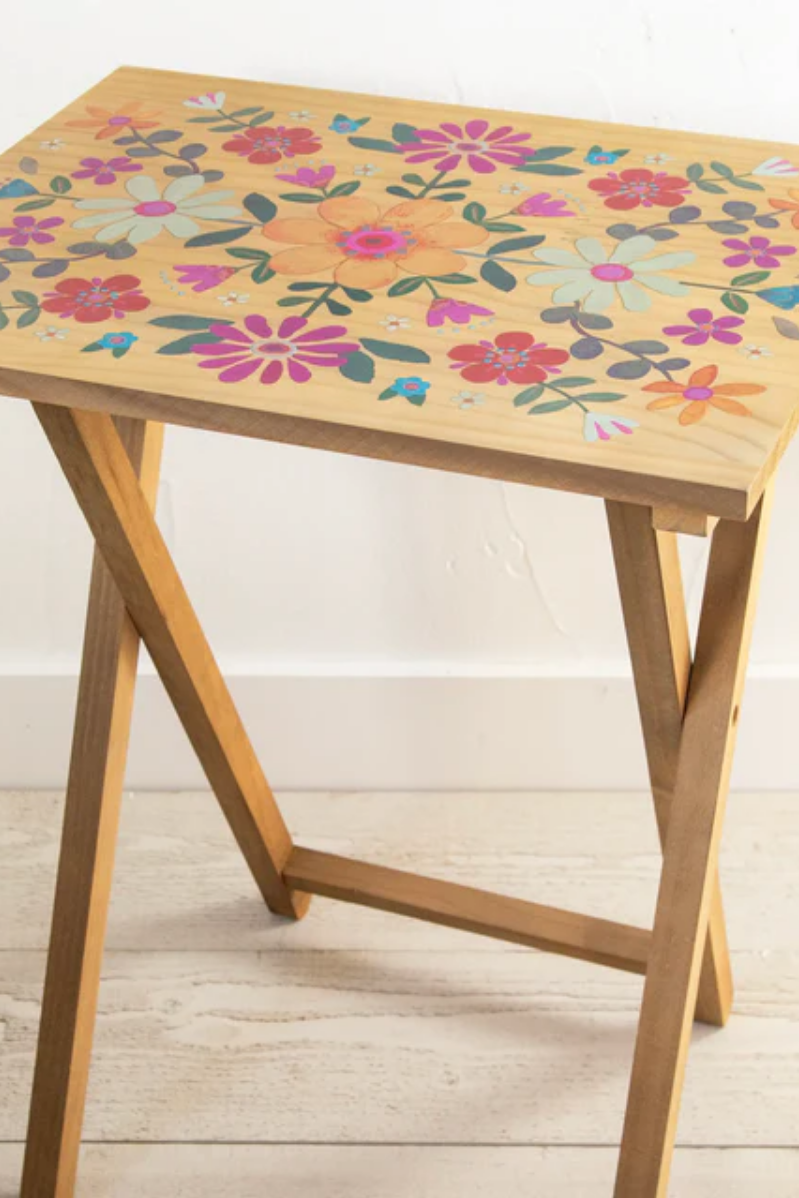 Wooden table with floral pattern on a light wooden floor
