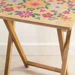 Wooden table with floral pattern on a light wooden floor
