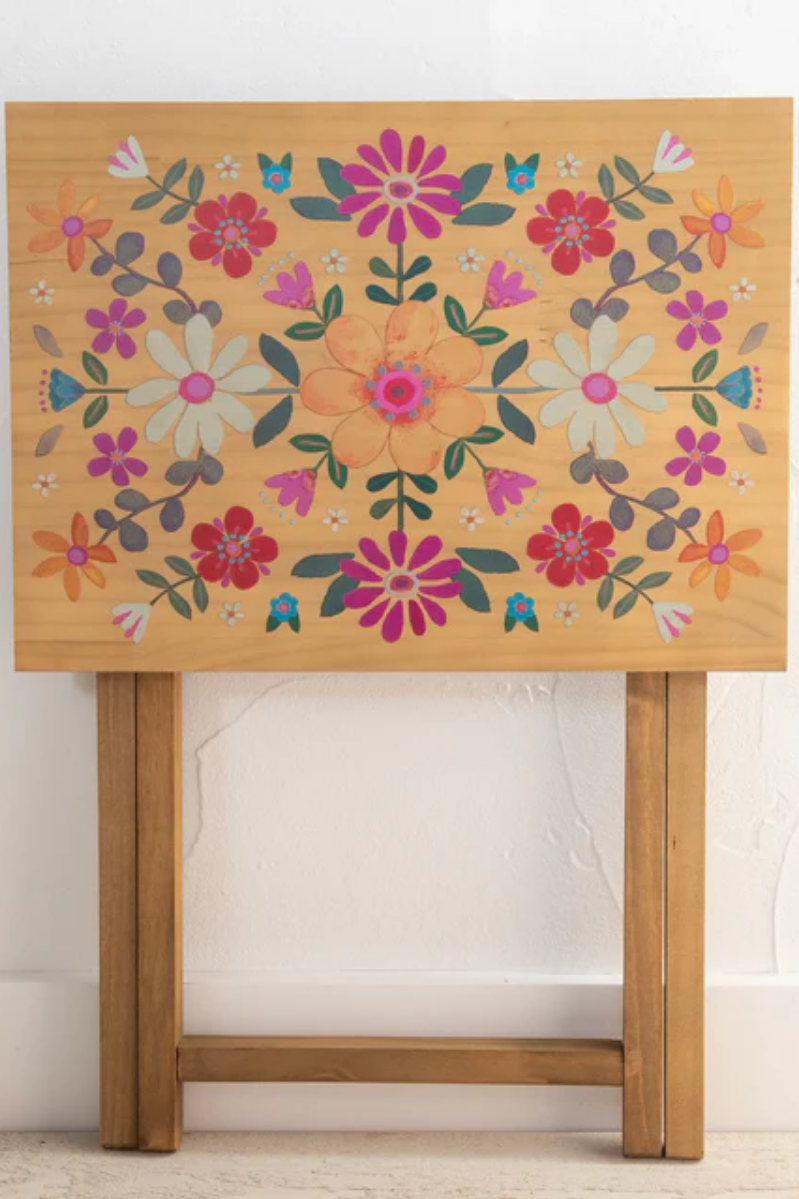 Wooden table with floral design on a white background