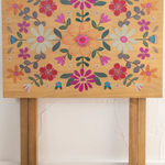 Wooden table with floral design on a white background