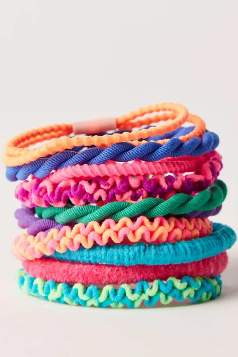 Stack of colorful textured hair ties on a white background