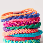 Stack of colorful textured hair ties on a white background