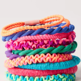 Stack of colorful textured hair ties on a white background