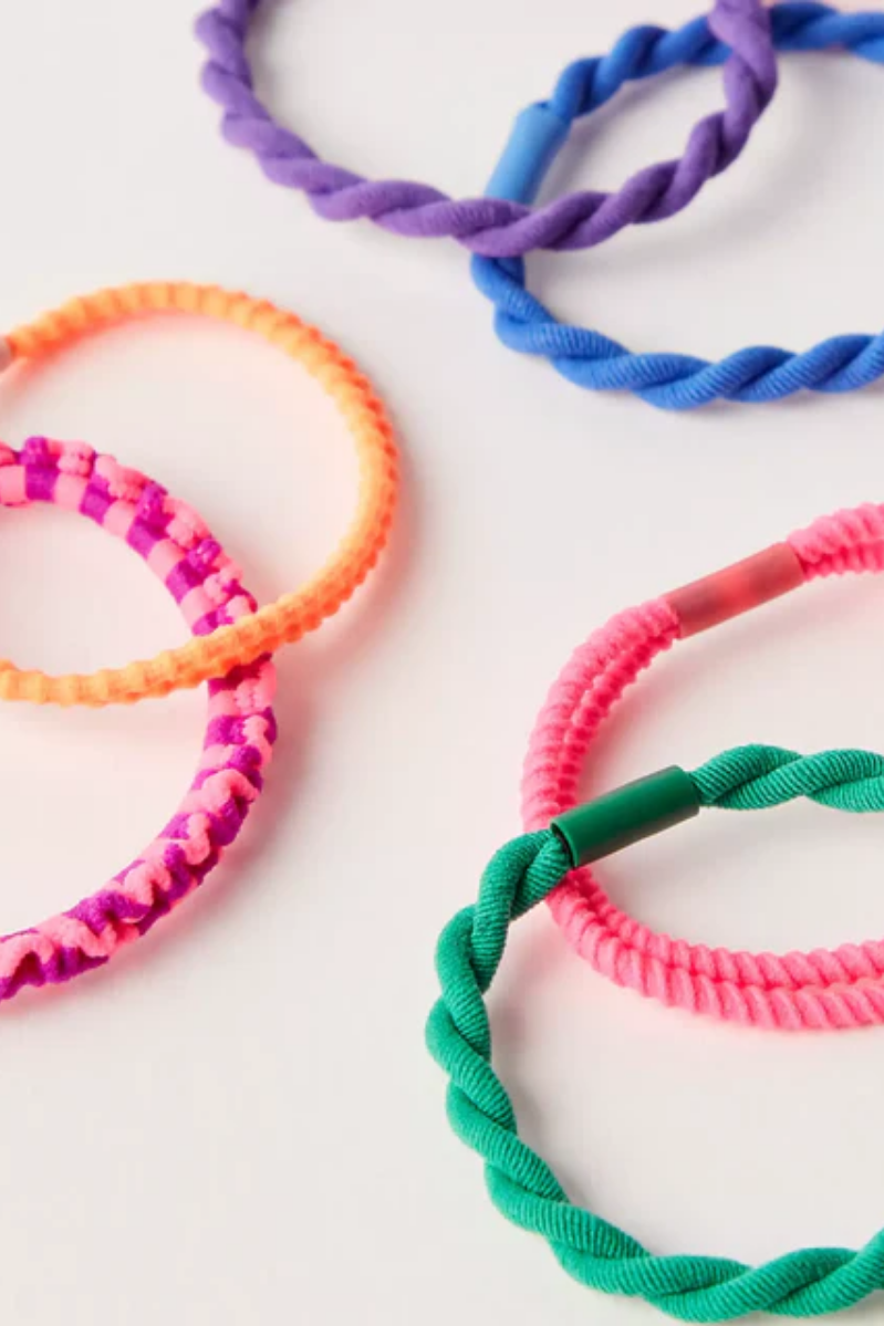 Colorful braided hair ties on a white background