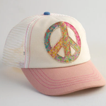 Cap with peace symbol design on a light gray background