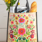 Floral-patterned tote bag with groceries on a wooden surface