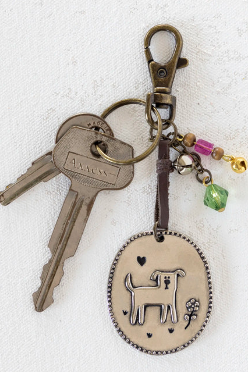 Keychain with dog charm and colorful beads on a white background