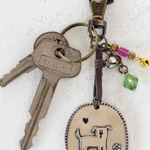 Keychain with dog charm and colorful beads on a white background