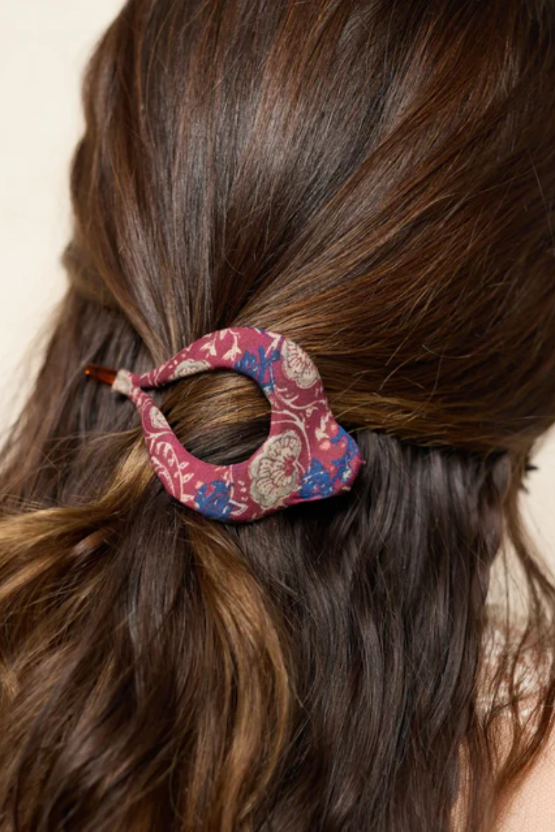 Close-up of a person's hair with a decorative hair clip.