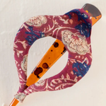 Decorative claw clip with floral pattern and orange accents on a white background