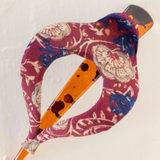 Decorative claw clip with floral pattern and orange accents on a white background