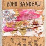 Floral boho bandeau with 'natural life' branding on a cardboard backing.