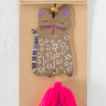 Cat-shaped air freshener with floral design on a cardboard backing