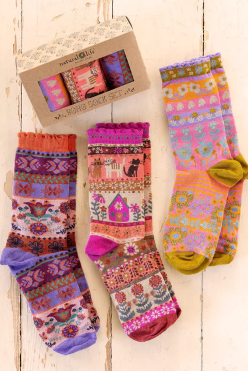Colorful patterned socks with a box on a wooden surface. Cat Sock Set of 3.