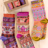 Colorful patterned socks with a box on a wooden surface. Cat Sock Set of 3.