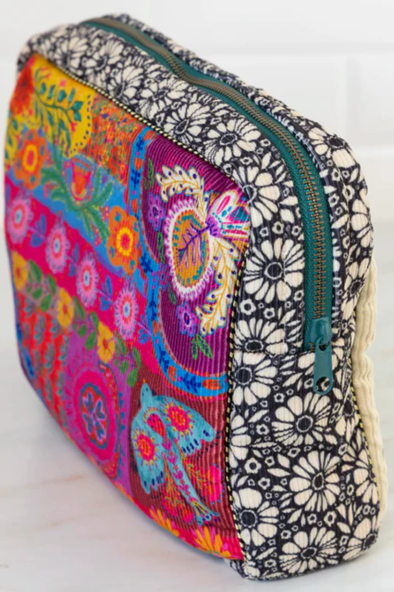 Colorful floral and geometric patterned pouch with a zipper on a white background